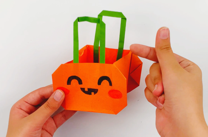 Two hands holding the Origami Halloween Gift Bag.