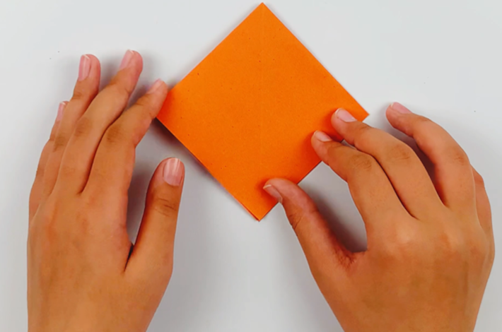 Two hands pressing the diamond shape flat. 