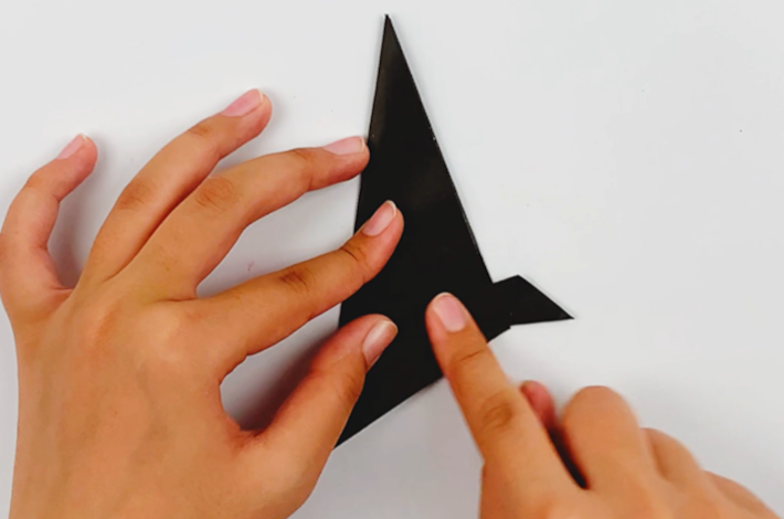 Two hands folding the right-hand point upwards again.