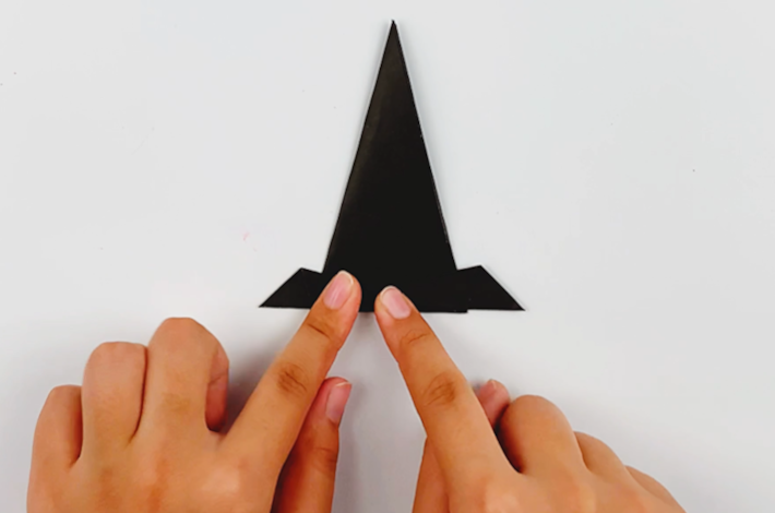 Two hands folding the left-hand point upwards again.