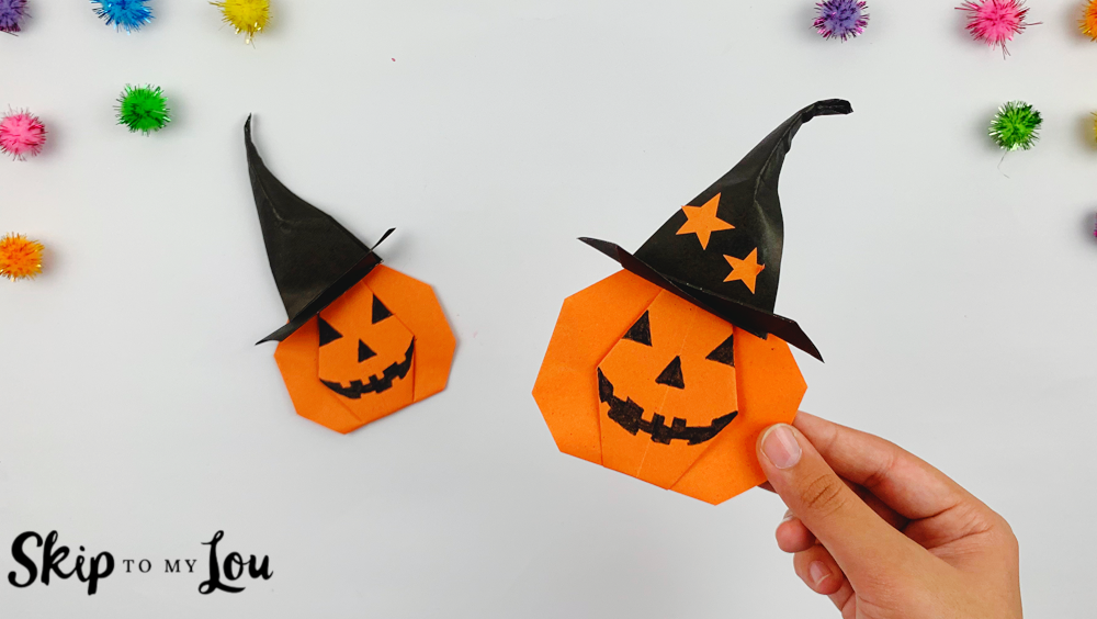 Two cute origami pumpkins whearing witches hats.