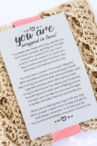 folded prayer shawl with prayer shawl poem attached