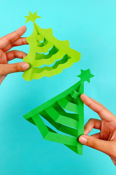 hands holding 3D paper trees