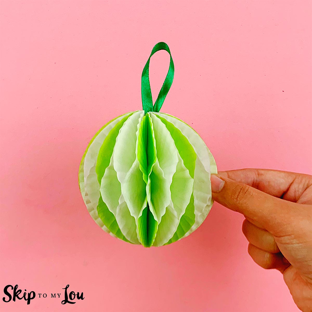 A paper ornament made from cupcake holders and instructions from Skip to My Lou.