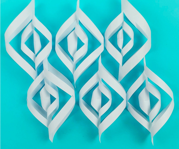 Six 3D paper snowflake sections ready to be glued together. 