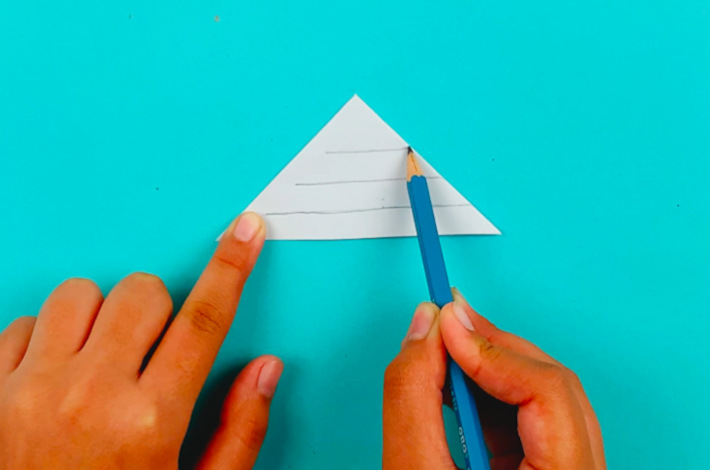 Two hands drawing three lines across the triangle, but not all the way through.