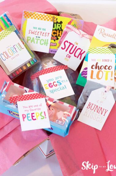 box filled with candy with cute tags attached with puns for Easter care package