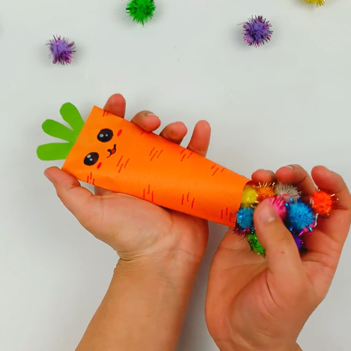 Two hands filling the inside of the carrot. You can use sweets if you'd like. 