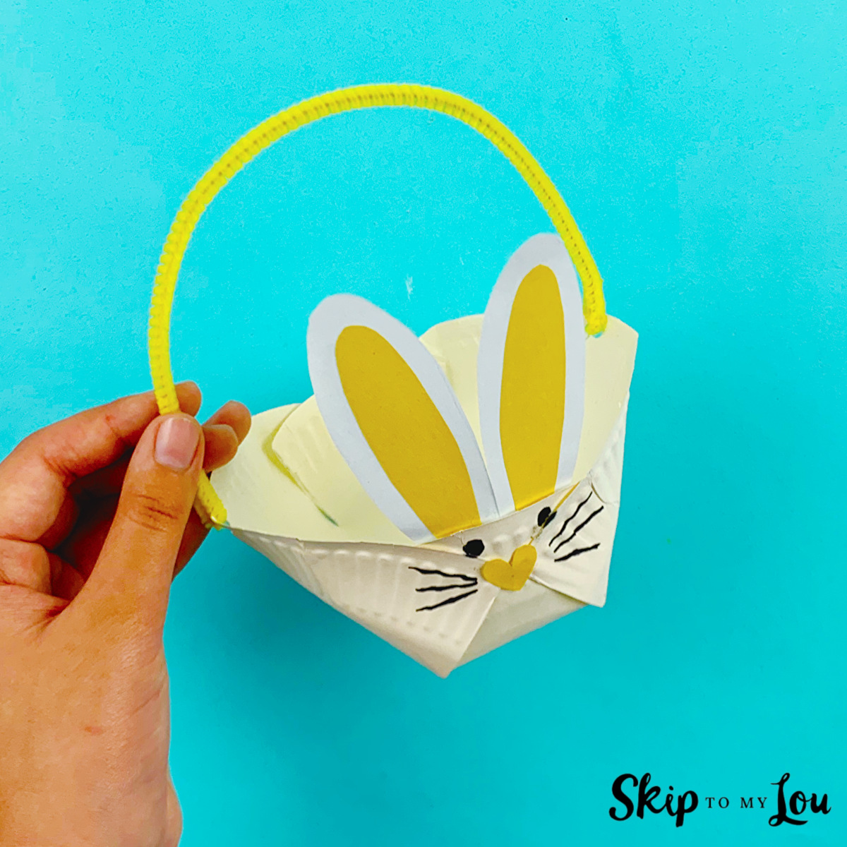 A paper plate bunny basket made with instructions from Skip to My Lou.