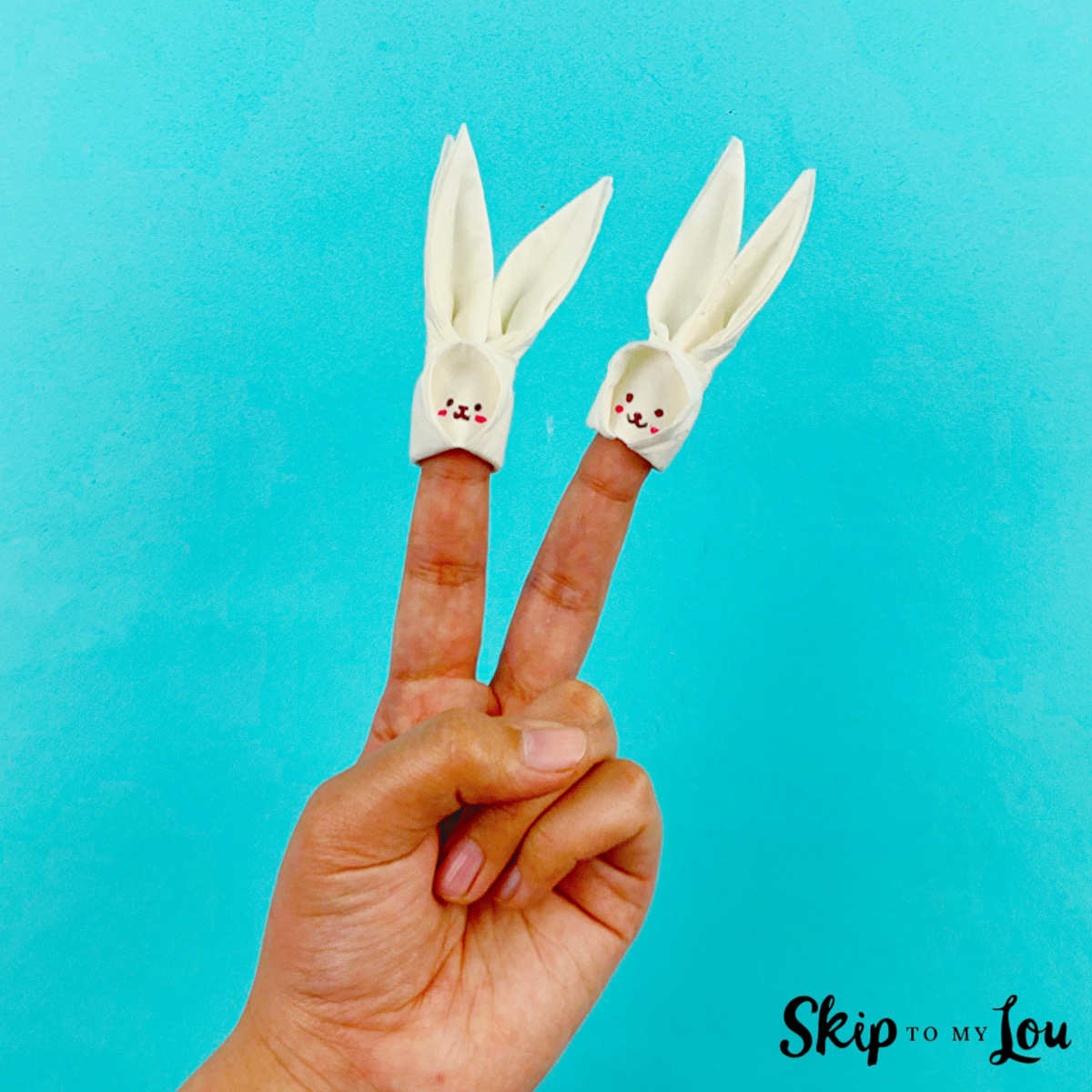 Two fingers with tissue paper bunny puppets made with instructions from Skip to My Lou.
