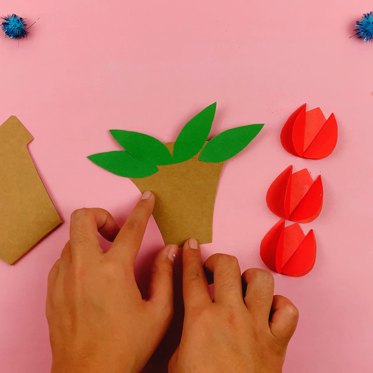 The leaves are glued to the top of the flower pot.