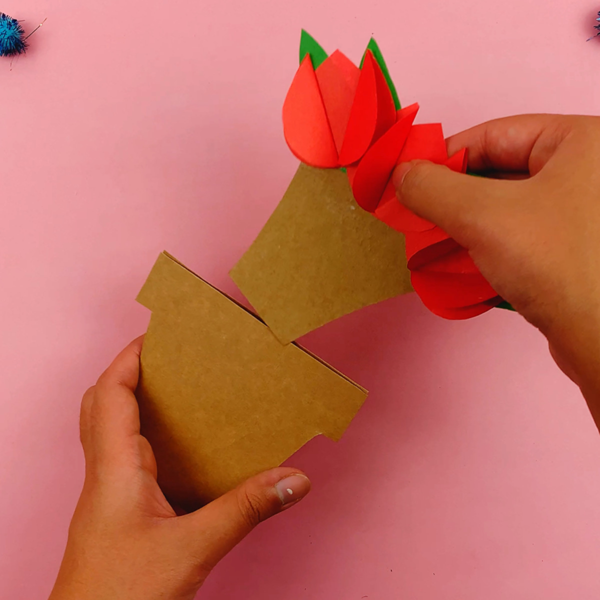 Two hands placing the insert into the flower pot template.