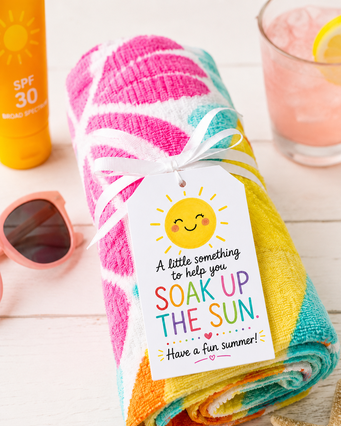 rolled up beach towel with cute printed tag "soak up the sun" teacher gift