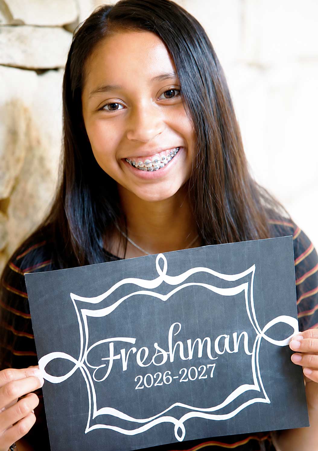 girl holding first day of school sign 2026 2027 school year